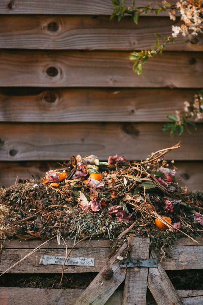Compost pile with dead leaves and kitchen scraps